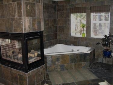 custom bathroom with fireplace and jacuzzi